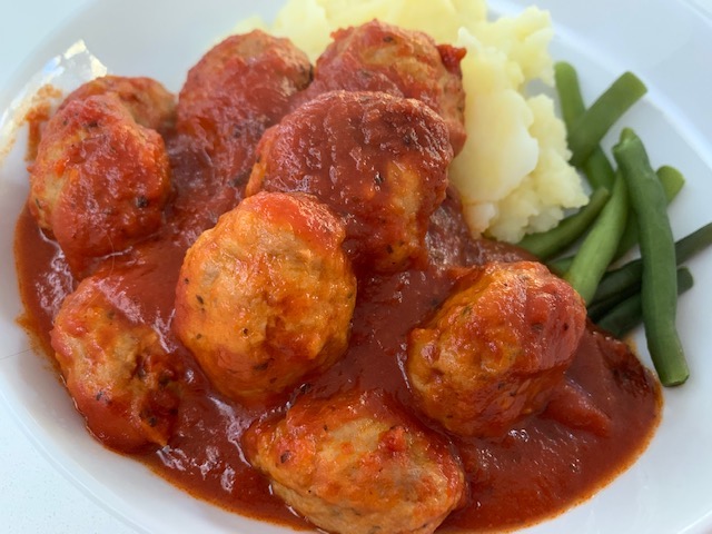 Meatballs In Tomato Sauce On A Bed of Mashed Potato.