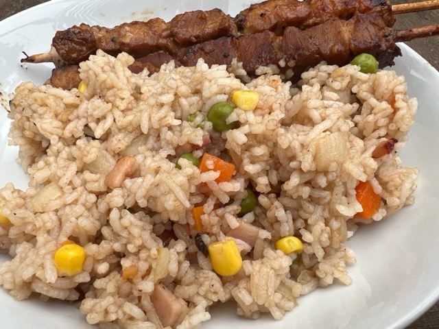 Fried Rice Served On A White Plate With 2 X Chicken Skewers.