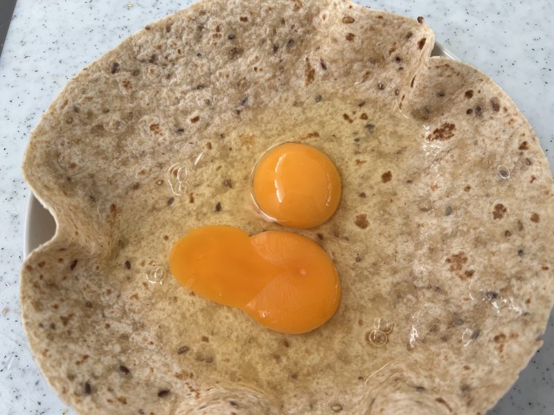 eggs broken into a wrap