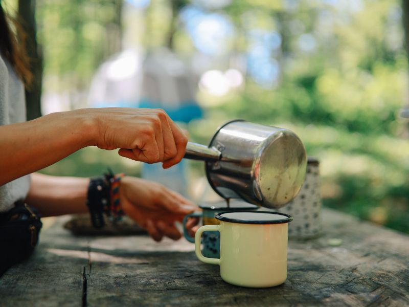 person making coffee while camping